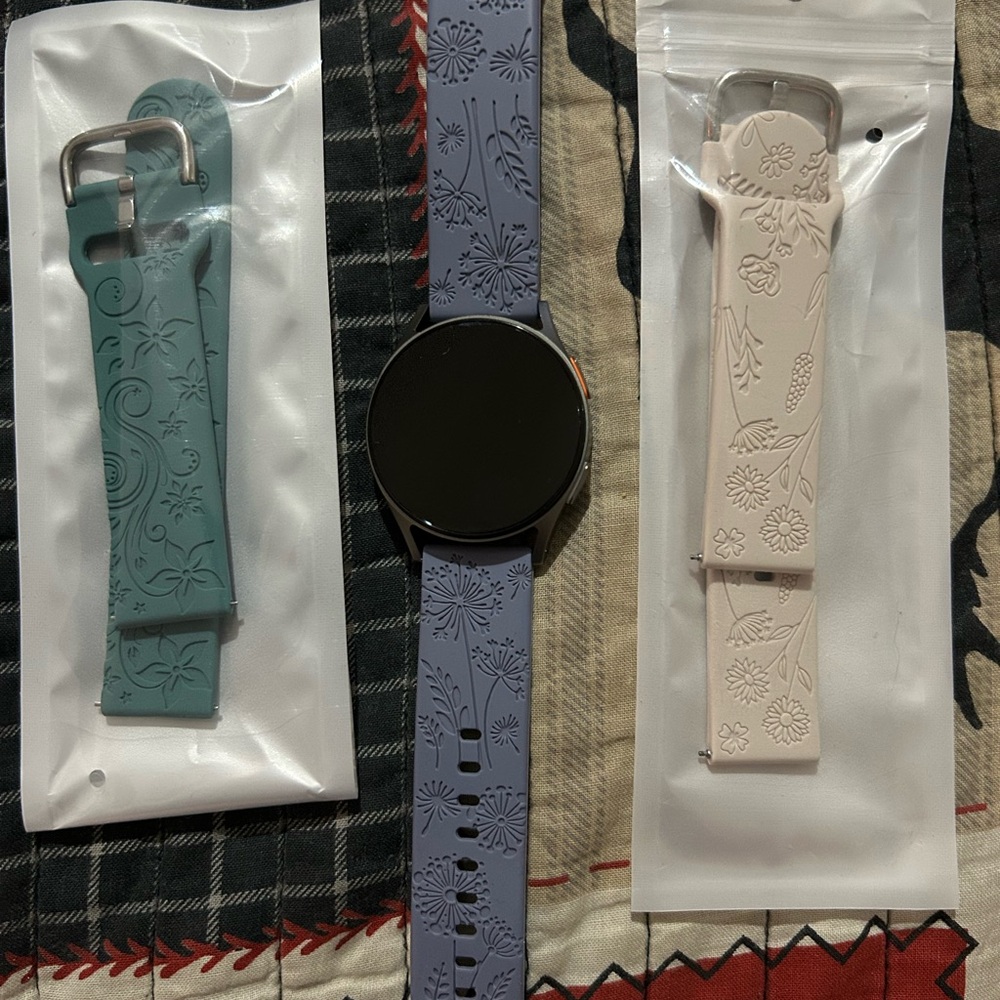 Samsung Galaxy Watch 7 with watch bands and charger